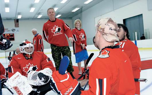 General Rick Hillier, Chief of the Defence Staff, and CPC President Carla Qualtrough speak with injured soldiers and members of Canada's National Sledge Hockey Team